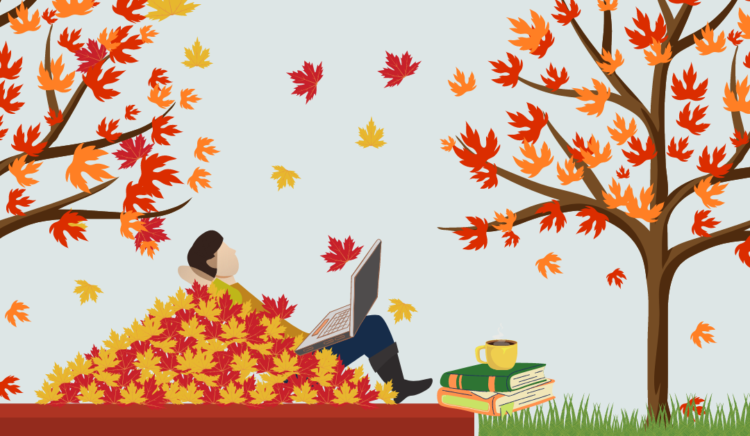 person laying on leaves with laptop